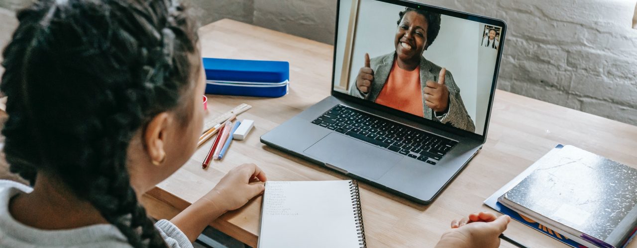 Person having a video call on a laptop with a mentor